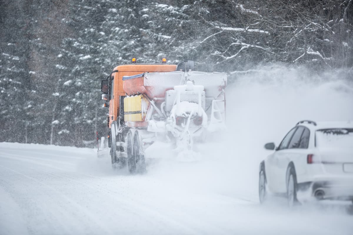 poor-road-visibility-car-driving-right-snow-plow-winter-road-maintenance (1)